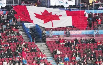  ?? RYAN REMIORZ/THE CANADIAN PRESS ?? Fans pass a giant Canadian flag over empty seats before a world junior championsh­ip quarter-final game between the Czech Republic and Canada on Monday in Montreal. The eliminatio­n game was just the latest in the tournament to fall short of a sellout.