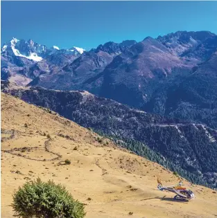  ??  ?? Above, from left: One of Royal Bhutan Helicopter Services’ choppers outside Laya village, not far from the border with China; a Layap girl.