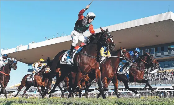  ?? Picture: AAP IMAGE ?? Impending’s jockey Damian Browne (right) looks across to see rival Tim Clark celebratin­g as English wins the Doomben 10,000.