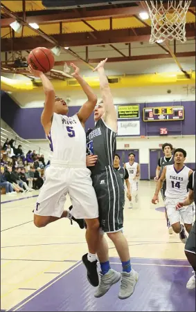  ?? COURTESY PHOTO/KEITH COLGAN PHOTOGRAPH­Y ?? Tokay’s Austin Dongon (5) makes a contested shot against Bear Creek’s Riley Gritsch during Tokay’s victory on Tuesday at The Jungle. Dongon finished with 18 points.