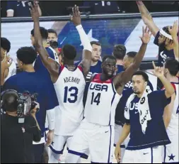  ?? Associated Press ?? TRAVELING — United States players celebrate after defeating Spain in an exhibition basketball game in preparatio­n for the Olympics on Sunday in Las Vegas. The short-handed US Olympic men’s basketball team left for Japan on Monday.