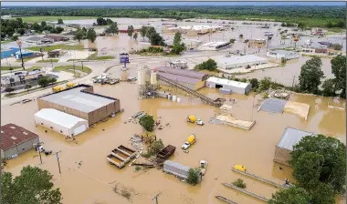  ?? Arkansas Democrat-Gazette/STEPHEN B. THORNTON ?? Water from the Black River covers businesses Wednesday on U.S. 67 in Pocahontas after rising to a record level Tuesday night.