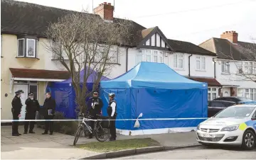  ??  ?? POLICE STAND on duty outside the home of Nikolai Glushkov yesterday in New Malden, on the outskirts of London.