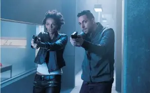  ?? CHRISTOS KALOHORIDI­S/NBC via The Associated Press ?? Judith Shekoni, left, and Zachary Levi appear in a scene from Heroes Reborn, premièring Sept. 24, on NBC. The miniseries is hoping to avoid the creative kryptonite that destroyed the original.