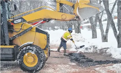  ?? DAVE STEWART • THE GUARDIAN ?? Despite the stormy weather, a crew with Charlottet­own’s water and sewer utility spent Tuesday morning conducting repairs on a water main on Emerald Drive, between Queen Street and Trafalgar Street.