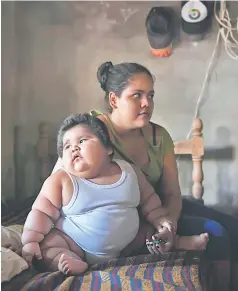  ?? — AFP photo ?? Ten-month-old Luis (left) and his mother Isabel are pictured at their home in Tecoman, Colima state, Mexico.