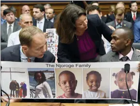  ?? AP PHOTO/SUSAN WALSH ?? Rep. Angela Craig, D-Minn., center, talks with Paul Njoroge, right, as Michael Stumo, left, looks on before the start of a House Transporta­tion subcommitt­ee hearing on Capitol Hill in Washington, Wednesday, July 17, 2019, on aviation safety. Njoroge lost his wife and three young children on Ethiopian Airlines Flight 302 and Stumo lost his daughter on the same flight. The plane was a Boeing 737 MAX.