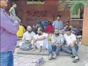  ?? HT PHOTO ?? Students sit outside the admin block at JNU. The university has sought HC’s help to remove protesters from the building.