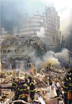  ?? ASSOCIATED PRESS ?? A shell of what was once part of the facade of one of the twin towers of New York’s World Trade Center rises above the rubble that remains after both towers were destroyed in the terrorist attacks on Sept. 11, 200l.