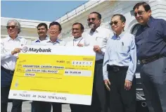  ??  ?? Penang Housing, Town and Country Planning Committee chairman Jagdeep Singh Deo (third right), who oversees the state fund on nonIslamic Religious Places of Worship, handing over a mock cheque for RM50,000 to Church of the Assumption Fundraisin­g...