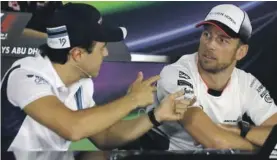  ??  ?? Williams driver Felipe Massa (left) speaks with McLaren driver Jenson Button Photo: AP