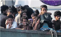  ?? REUTERS/ OLIVIA HARRIS ?? Migrants are seen aboard a boat tethered to a Thai navy vessel, in waters near Koh Lipe island.