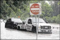  ?? PAT SULLIVAN / AP ?? A stranded vehicle is towed out of a flooded street in Houston. Forecaster­s are trying to understand why several people in Houston ignored warnings and died after driving onto flooded streets.