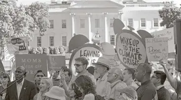  ?? Susan Walsh / Associated Press ?? Protesters gather near the White House after President Donald Trump announced his climate decision.