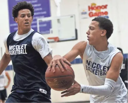  ?? CURT HOGG/NOW NEWS GROUP ?? Brothers Jalen (left) and Kobe Johnson of Nicolet compete during a drill at practice on Monday.