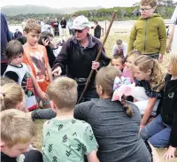  ??  ?? Pied piper . . . Papatowai Big Dig organiser Wayne Allen uses his ‘‘magic stick’’ to guide youngsters to a prize on New Year’s Eve.