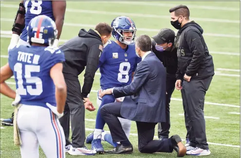  ?? Jamie Sabau / Getty Images ?? Trainers tend to Daniel Jones (8) of the New York Giants after he is injured during the second half against the Cincinnati Bengals at Paul Brown Stadium on Sunday in Cincinnati.