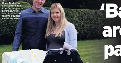  ??  ?? Karys Davies and her husband Ben, from Penllergae­r in Swansea, were one of the first to receive a bundle earlier this week.