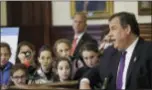  ?? SETH WENIG — THE ASSOCIATED PRESS ?? School children from Lakewood, N.J., watch as New Jersey Gov. Chris Christie speaks at a news conference in his offices in Trenton Monday.