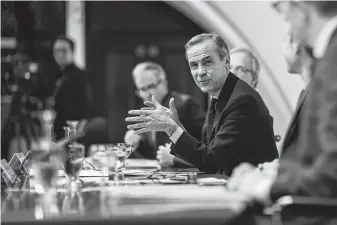  ?? Simon Dawson / Bloomberg ?? Mark Carney, governor of Bank of England, holds a news conference Wednesday. He warned that the U.K. could suffer the worst economic slump since World War II if the Brexit plan fails.