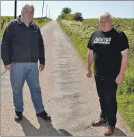  ?? 25_c23raggsro­ad01 ?? From left: Councillor­s John Armour and Donald Kelly stand beside the corrugated surface of the Castleragg­s Road.