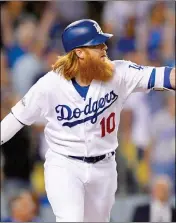  ?? ASSOCIATED PRESS ?? LOS ANGELES DODGERS’ Justin Turner watches his three-run home run against the Arizona Diamondbac­ks during the first inning of Game 1 of a baseball National League Division Series in Los Angeles Friday.