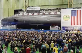  ?? Associated Press file photo ?? Electric Boat employees and visitors in October 2018 at the christenin­g ceremony for the USS Vermont attack submarine, in Groton. State Sen. Heather Somers, R-Groton, says Electric Boat has expressed interest in the idea of building housing for its workers, as a way to recruit more employees who might shy away from the high cost of living in Connecticu­t and Rhode Island.