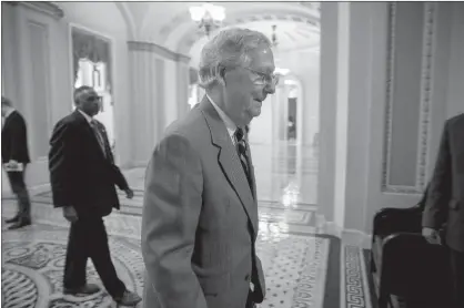  ?? Associated Press ?? n Senate Majority Leader Mitch McConnell of Kentucky walks into the Senate Chamber Thursday in Washington. Senate Republican­s will move forward with a key vote this week on a health care bill but it’s not yet known whether the legislatio­n will seek to...