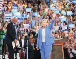  ?? BRYCE VICKMARK/ZUMA PRESS FILE PHOTOGRAPH ?? Hillary Clinton greets the crowd along with Sen. Bernie Sanders during an event where she was endorsed by Sanders at Portsmouth High School on July 12, 2016, in Portsmouth, N.H.