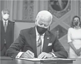  ?? JIM LO SCALZO/AP, POOL ?? President Joe Biden signs three documents, including an inaugurati­on declaratio­n, cabinet nomination­s and sub-cabinet nomination­s, in the President’s Room at the Capitol after the inaugurati­on.