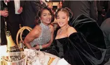  ?? Christophe­r Polk /NBC/Getty Images ?? Angela Bassett, left, wore Pamela Rolland sequins, while Rihanna wrapped up a black velvet Schiaparel­li bustier dress.