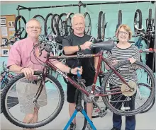  ?? SCOTT ROSTS METROLAND ?? Start Me Up Niagara launches its Bike Me Up Niagara project at 203 Church St. in St. Catharines. In the workshop are, from left, board chair Bob Hillier, bike shop manager Wayne Schmidt and Start Me Up Niagara executive director Susan Venditti.