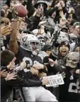  ?? MARGOT ?? Oakland Raiders running back Jalen Richard (30) celebrates with fans after scoring a touchdown against the Denver Broncos during the second half of an NFL football game in Oakland on Sunday. AP PHOTO/BEN