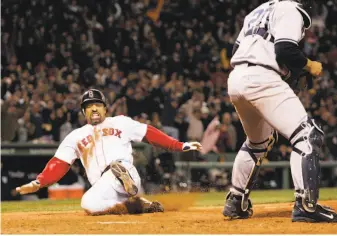  ?? Elise Amendola / Associated Press 2004 ?? Dave Roberts placed himself forever in Boston lore by stealing second base, then sliding home to score the tying run against the Yankees in Game 4 of the 2004 ALCS.