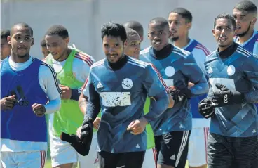  ?? /Ashley Vlotman/Gallo Images ?? Aspiring giant killers: Magic FC footballer­s warm up at a training session at their modest headquarte­rs ahead of their Cup tie against Kaizer Chiefs on Sunday