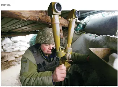  ?? Photo: AFP ?? A member of the Ukrainian armed forces keeps watch on the front line with Russia-backed separatist­s in the Donetsk region.