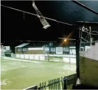  ??  ?? Damage to the main stand roof and flooding at Bacup Borough FC