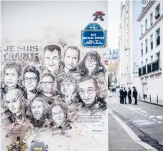  ?? AFP2019 STEPHANE DE SAKUTIN/GETTY- ?? A painting pays tribute to members of the Charlie Hebdo newspaper who were killed in January 2015 in Paris.