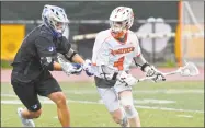  ?? H John Voorhees III / Hearst Connecticu­t Media ?? Ridgefield’s John Mathes, right, moves with the ball against Darien’s Blake Sommi on Saturday.