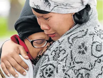  ?? Picture: ESA ALEXANDER ?? SHOCKING LOSS: Relatives of Jason Hartzenber­g, 21, who was killed in the Rheinmetal­l Denel munitions plant blast, break down outside the entrance of the plant on Tuesday