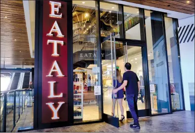  ?? AP/RICHARD VOGEL ?? Customers arrive last month at the Eataly food market in the Westfield Century City mall in Los Angeles. Many mall owners are spending billions of dollars on amenities to attract shoppers.