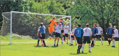  ??  ?? Saints goalkeeper Graham Douglas punches the ball clear during the game against Inverclyde.