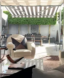  ??  ?? Right: A retractabl­e striped awning keeps this Takapuna townhouse shaded during the summer.