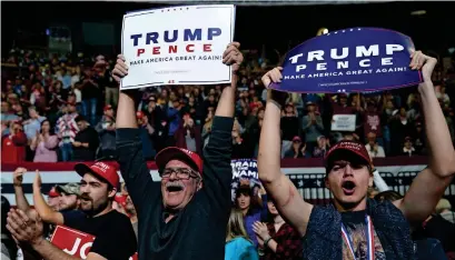  ??  ?? Supporters of President Trump hold up signs during a campaign rally for Rep. Marsha Blackburn and other Tennessee Republican candidates at the McKenzie Arena in Chattanoog­a, Tennessee. — AFP