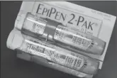  ?? JOE RAEDLE/GETTY IMAGES ?? This photo illustrati­on shows an EpiPen, which dispenses epinephrin­e through an injection mechanism for people with severe allergies.