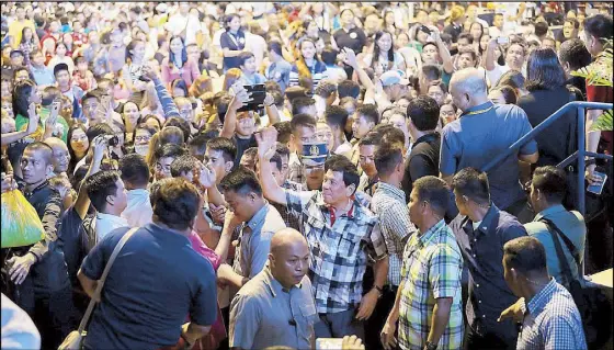  ??  ?? President Duterte interacts with Negrenses who attended the opening ceremony of the Buglasan Festival 2017 at the Lamberto Macias Sports and Cultural Center in Dumaguete City, Negros Oriental the other night.