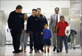  ?? PATRICK SEMANSKY — THE ASSOCIATED PRESS ?? Darwin Micheal Mejia, third from right, and his mother, Beata Mariana de Jesus Mejia-Mejia, right, are escorted to a news conference after their reunion at BaltimoreW­ashington Internatio­nal Thurgood Marshall Airport on Friday in Linthicum, Md. The Justice Department agreed to release Mejia-Mejia’s son after she sued the U.S. government in order to be reunited following their separation at the U.S. border. She has filed for political asylum in the U.S. following a trek from Guatemala.