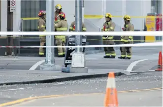  ?? GAVIN YOUNG ?? Shards of glass cover the road after a pane fell from Brookfield Place tower onto 1 Street S.W. between 6th and 7th avenues Sunday. Several roads have been shut down until safety can be assured.