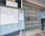  ??  ?? REUTERS A security guard outside a bank in Guwahati