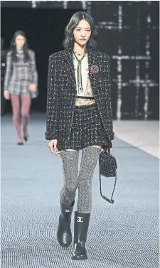  ?? PASCAL L E S EGRETAIN GETTY I MAGES ?? School-girl plaid was back on many fall 2022 runways (including Chanel seen here), along with the return of ’90s minimalism and neutral brown, which has been having a moment since 2019.